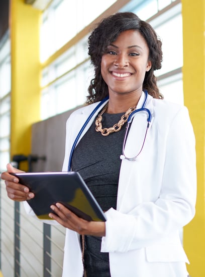 Physician in white coat with tablet