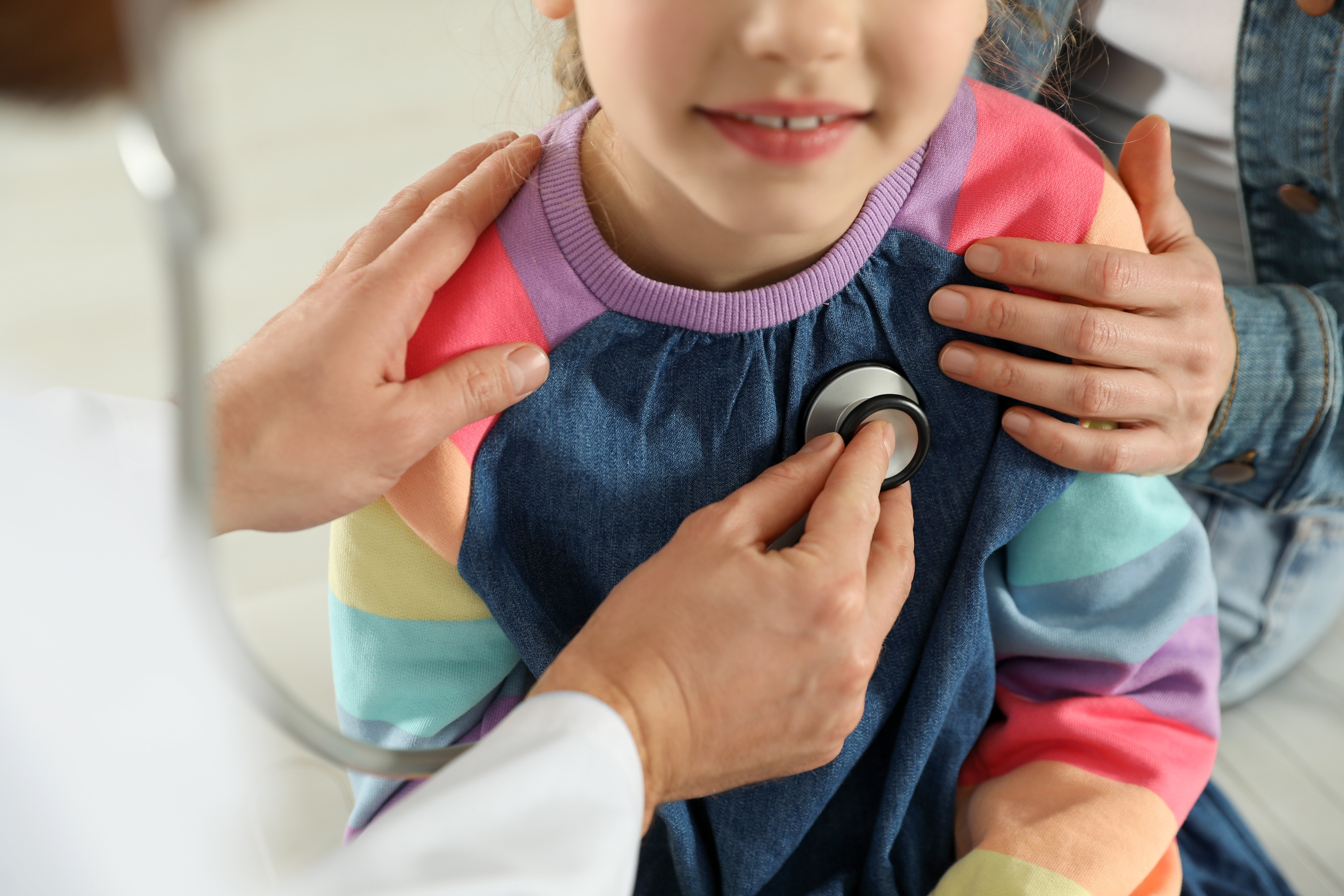 Physician checking child's heart with a stethoscope